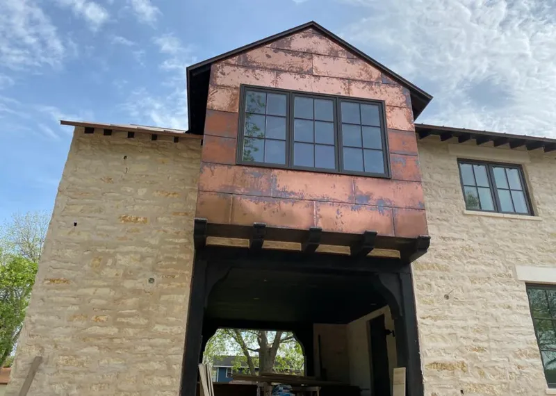 Copper metal panel facade on a stone building for Skylight Installation in Tarpon Springs